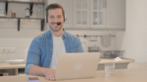 man wearing headset and macbook