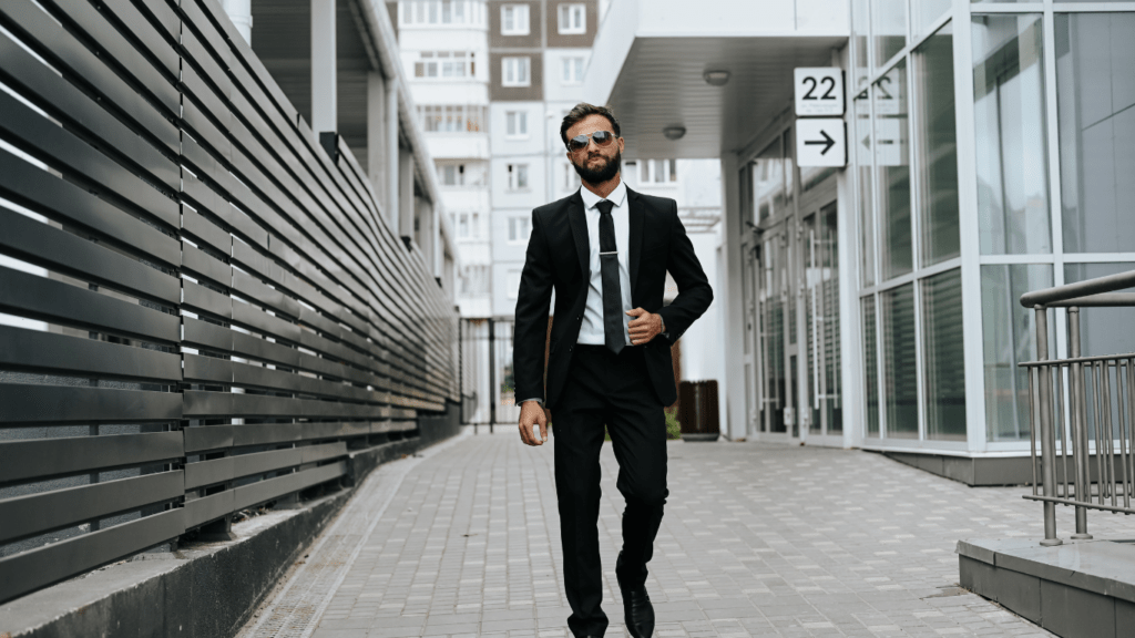 a person in a suit and tie walking down a street