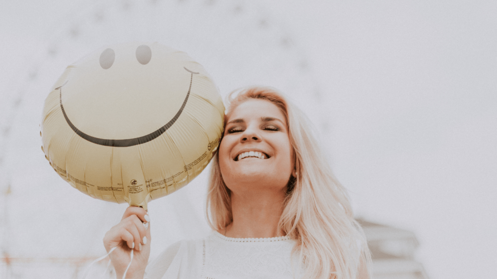 A person holding a smiley face