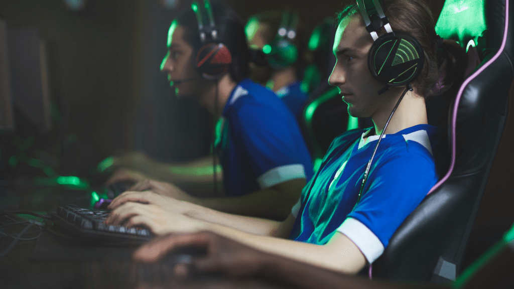 a group of people playing video games in a dark room