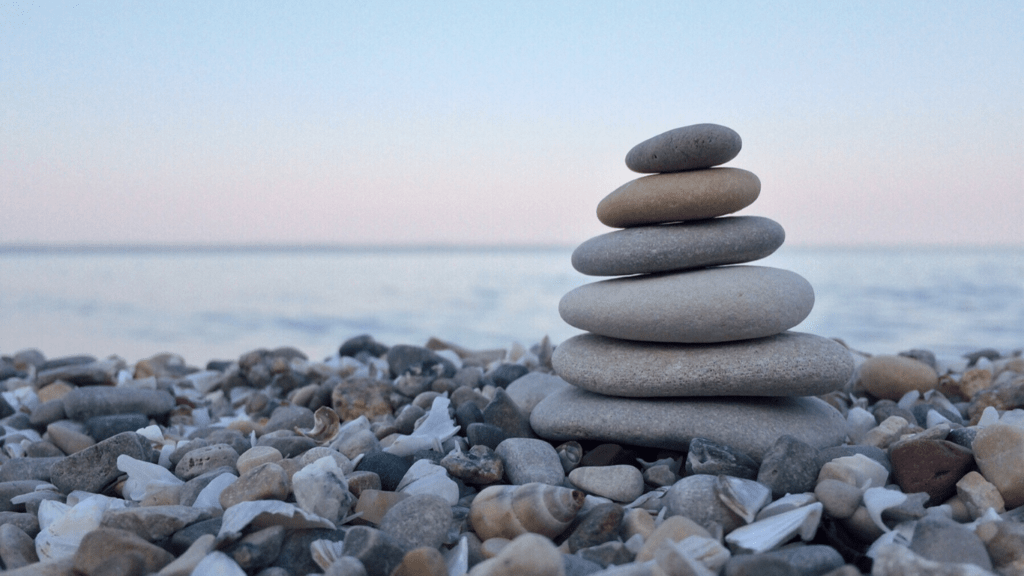 a stack of pebbles is sitting on the beach