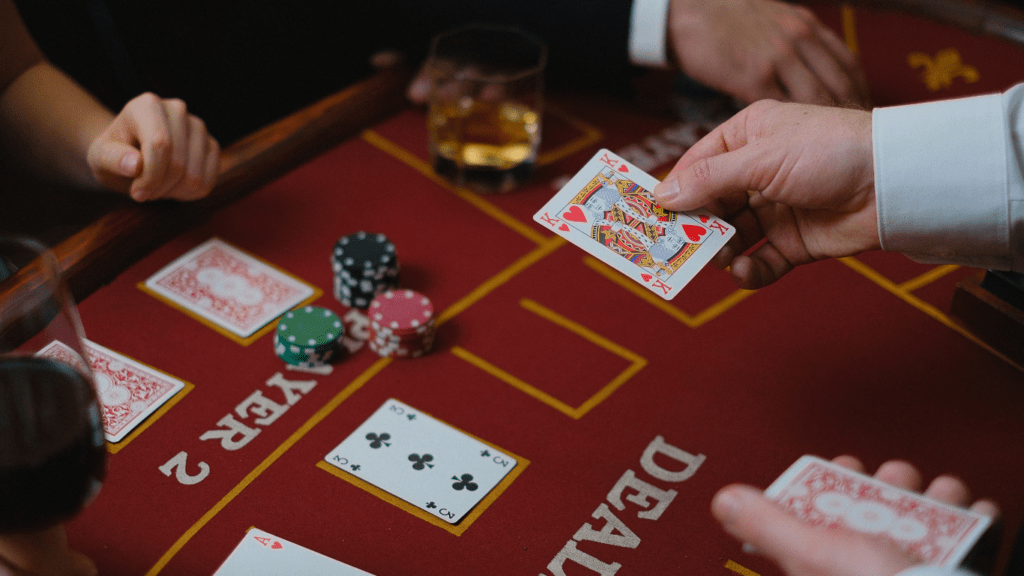 a group of people playing blackjack at a casino table