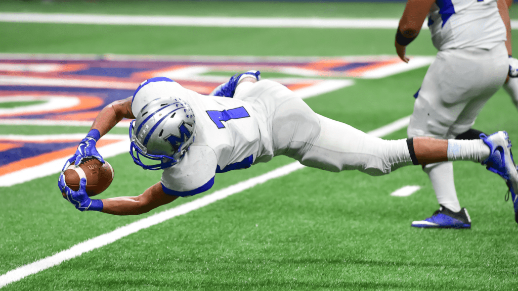 a football player runs with the ball during a game