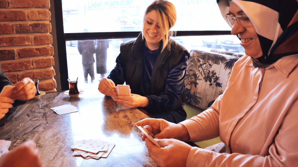 a group of people playing cards at a table