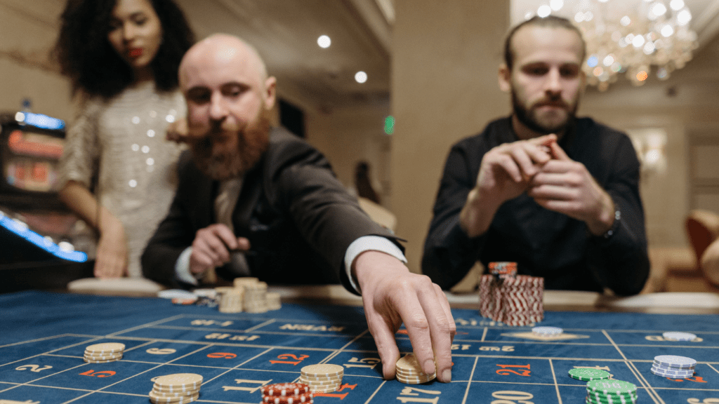 a group of people playing roulette at a casino table