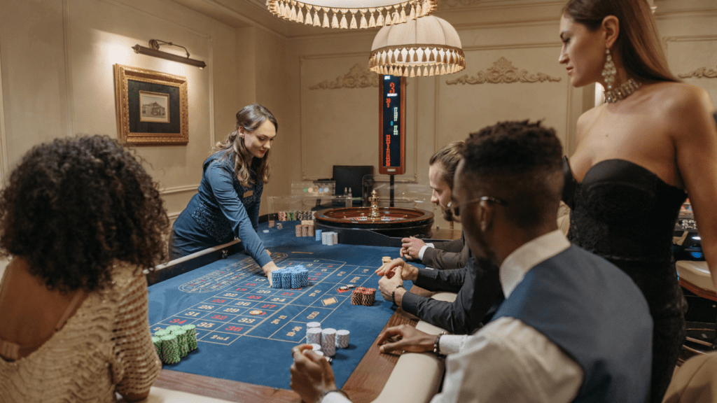 a group of people playing roulette in a casino