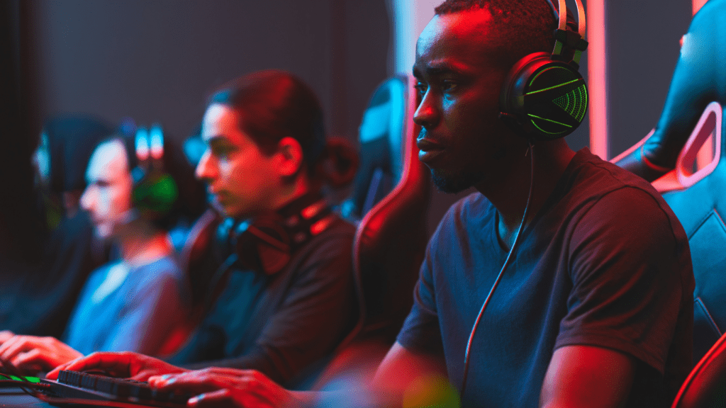 a group of people playing video games in a dark room