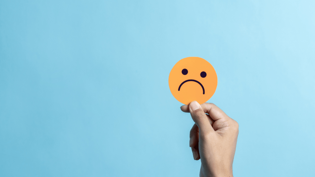 a person holding a emoticon sign