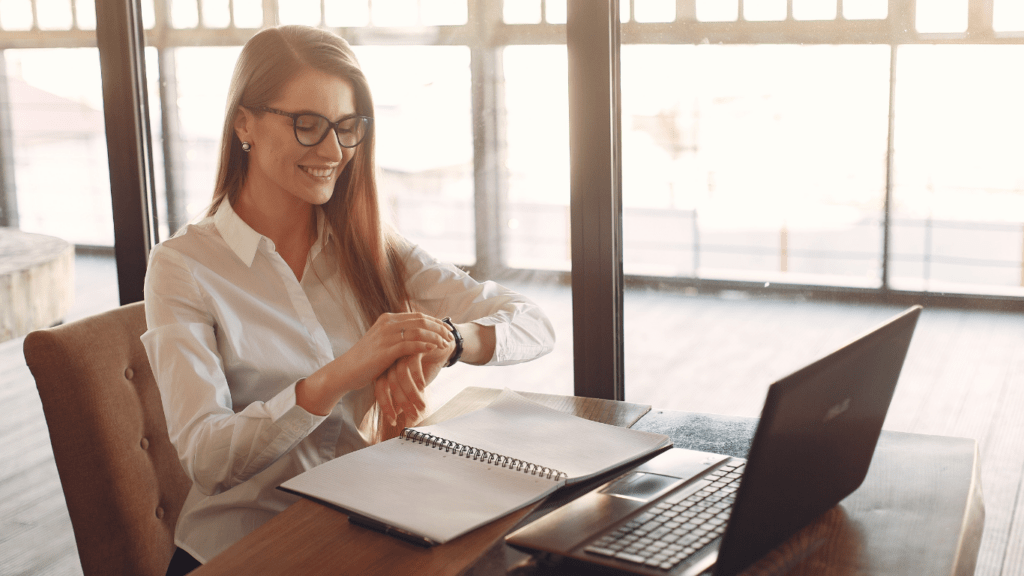 a person sitting at a desk with their hand on their wrist