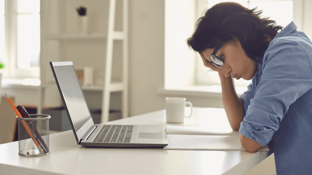 a person using a laptop at the table