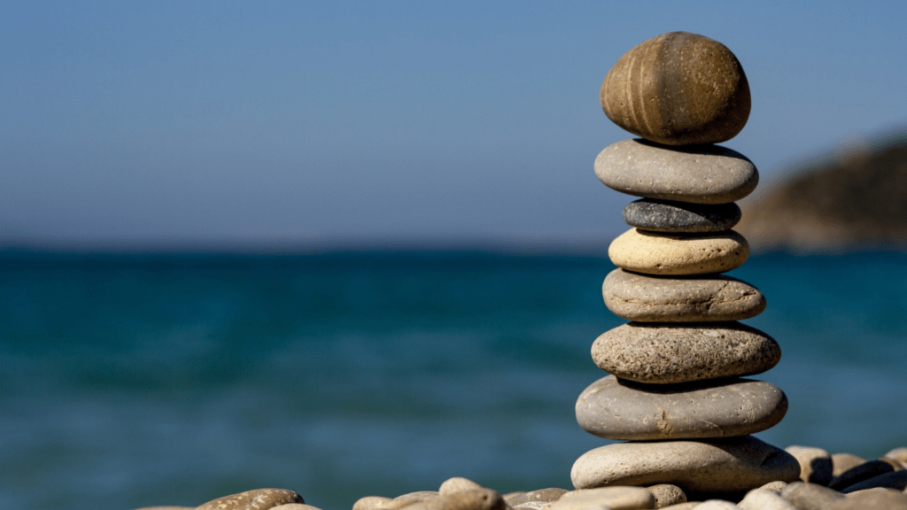 a stack of pebbles is sitting on the beach